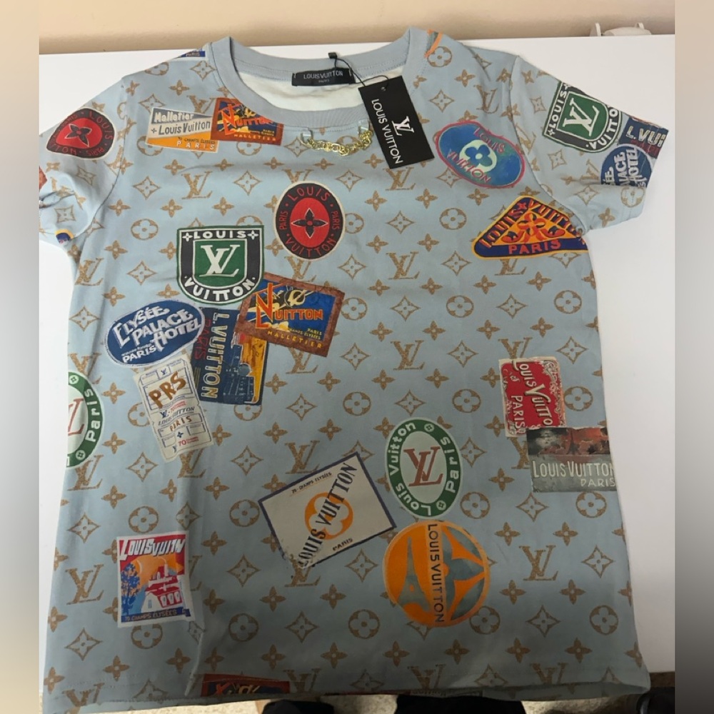 Light blue Top with Gold Monogram and Colorful Patch Logos